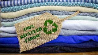 Recycle clothes icon on fabric label with 100% Recycled text, concept illustration reuse, recycle clothes and textiles to reduce waste