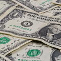 Pile of used US dollars partial cash bills money closeup finance economy concept.