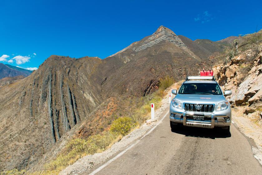 Toyota Landcruiser on a narrow road crossing the Cordillera Central of the Andes, Northern Peru, South America