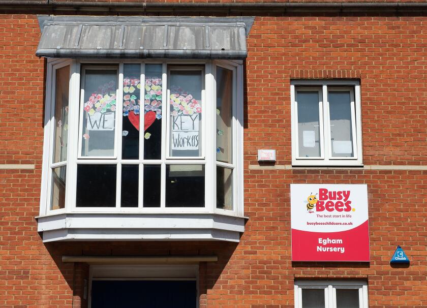 Egham, Surrey, UK. 20th May, 2020. A large 'We love you key workers' rainbow in the window of the Busy Bees Nursery in Egham, Surrey during the Coronavirus Covid-19 Pandemic lockdown. Credit: Maureen McLean/Alamy