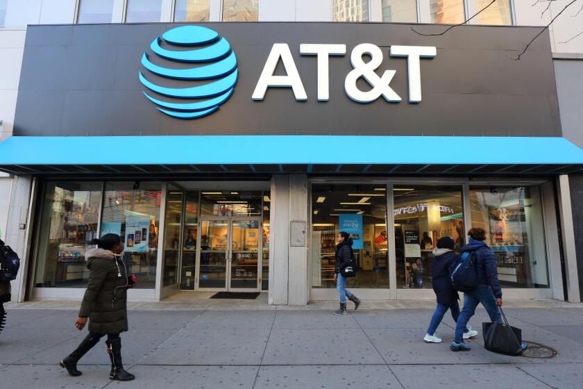 AT&T Store, 476-478 Fulton St, Brooklyn, NY. the gigantic logo of a telecommunications company and cellphone shop overlook shoppers on the Fulton Mall