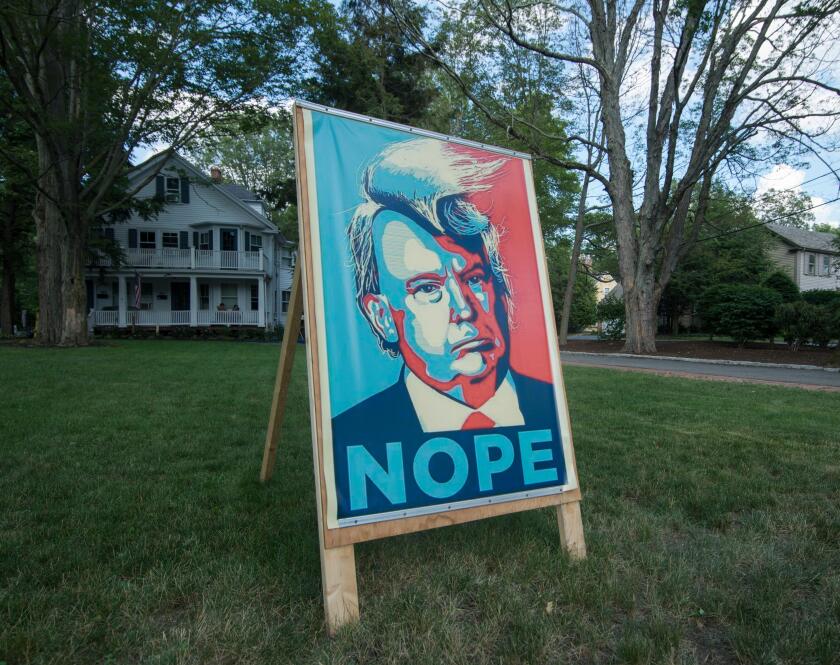 Lexington, Massachusetts, USA.  13th July, 2016.  A Lexington, MA, democrat made a 3 foot by 5 foot poster protesting the Republican Presidential candidate, Donald Trump, mounted it on a homemade wooden easel and placed it in his front yard on Massachuset