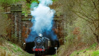 LMS 0-6-0 4F locomotive seen steaming from the Nuttall Park tunnel on the East Lancashire heritage railway towards Ramsbottom.