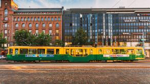 Tram departs from a stop on street Aleksanterinkatu in Helsinki