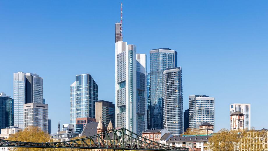 Frankfurt skyline skyscrapers with banks on River Main with bridge excursion boats in Frankfurt, Germany