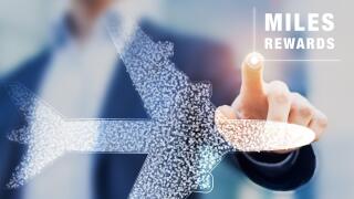 Air miles rewards with person touching airplane shape, frequent flyer loyalty program to earn points and bonuses for travel benefits like elite cards,