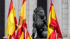 Sculpture of lion in the Congress of Deputies of Madrid with Spanish flags
