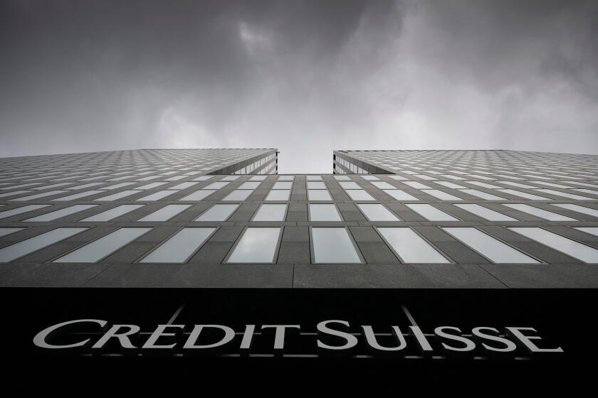 FILE - Grey clouds cover the sky over a building of the Credit Suisse bank in Zurich, Switzerland, Feb. 21, 2022. Swiss regulators have found that Credit Suisse made a ?serious breach? of law in connection with a now-bankrupt firm linked to Australian fin
