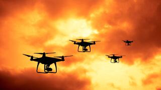 silhouette of drones in formation