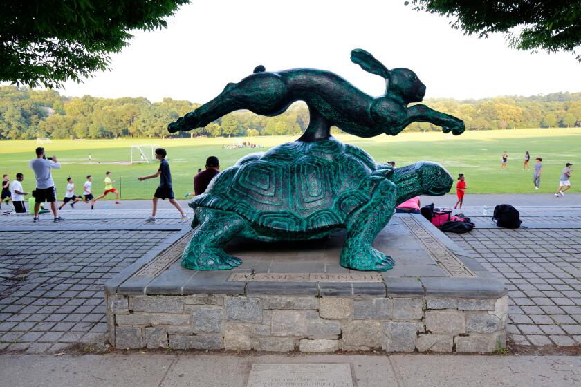 Runners near the Tortoise and Hare statue at Van Cortlandt Park