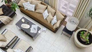 Meringues and tea on coffee table with chrome legs in front of Gervasoni rattan sofa with pillows and leather ottoman in orangery 


UK AND IRISH RIGH