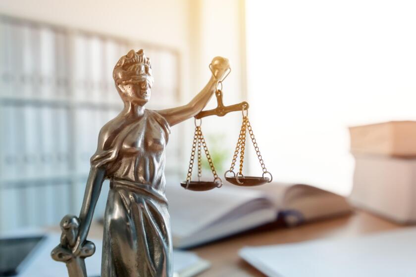 Lady Justice statue in law firm attorney office, blindfolded Justitia with balance scales and sword is personification of moral force in judicial syst