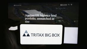 Stuttgart, Germany, 05-29-2024: Person holding cellphone with logo of British property company Tritax Big Box REIT plc in front of business webpage. F