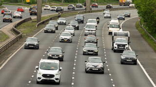 Cars and trucks travel along the M6 north in Warrington during a bustling afternoon, showcasing the rhythm of everyday life on this major highway.