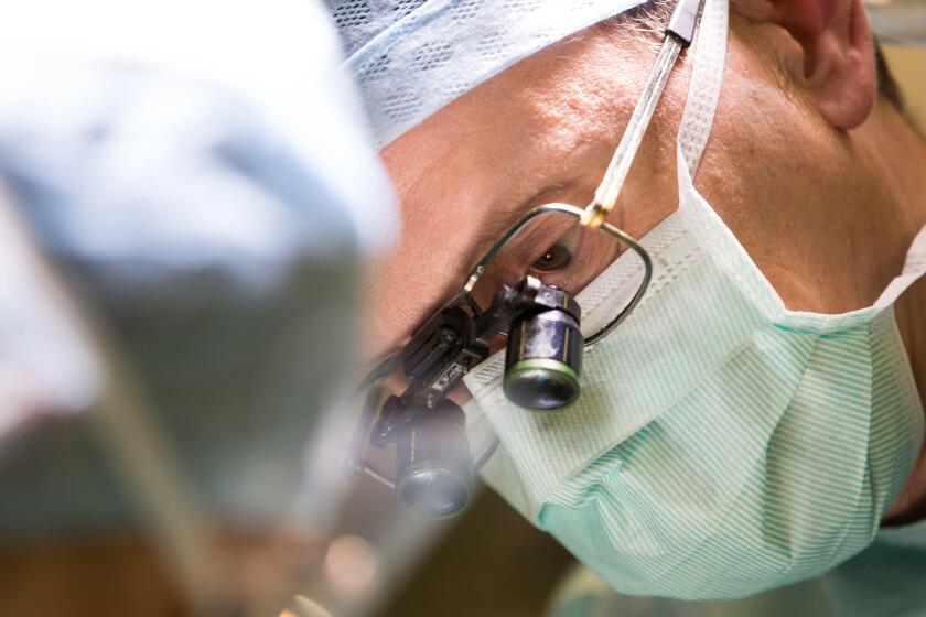 Carlos Heras-Palou, 53, performing hand surgery at Derby Nuffield Hospital. Mr Heras-Palou, an orthopaedic specialist surgeon, may have had his career saved by a new drug called 'Patisiran'. The rare disease, hereditary transthyretin-mediated amyloidosis 