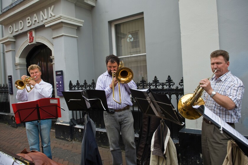 St Petersberg Brass Baroque Quartet busking on the street during Abergavenny Food Festival Monmouthshire South Wales UK