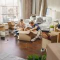 Happy Young Homeowners Moving In: Happy Couple Sitting on the Floor of the Newly Purchased Apartment Unpacking Cardboard Boxes. Mortgage Loan, Real Estate, Home Sweet Home for Young Family