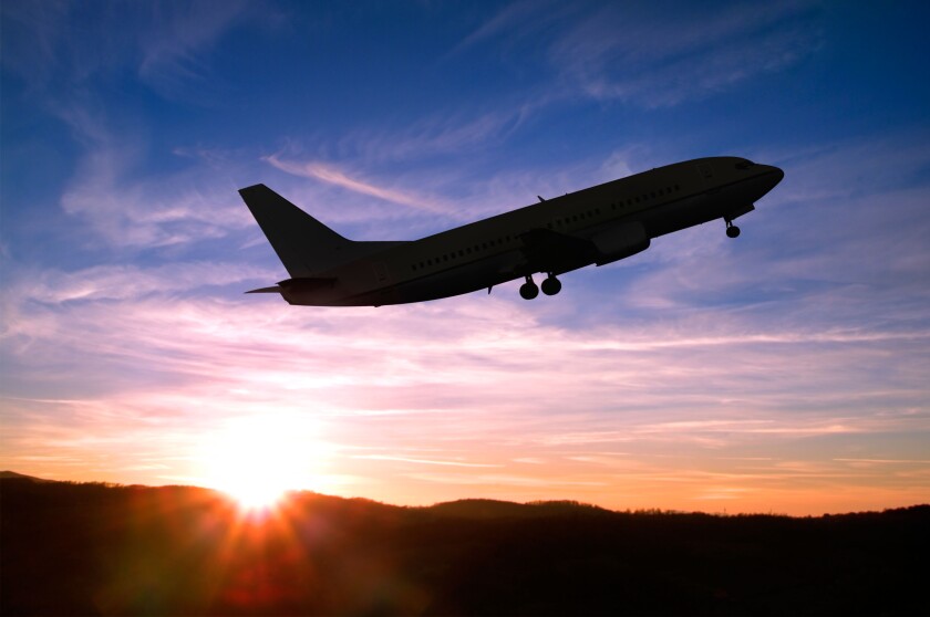 Airplane Taking Off into a Sunset.