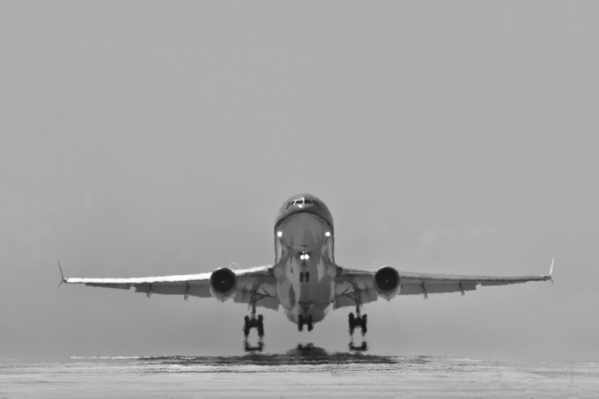 Bonaire Island, Dutch Caribbean, Kralendijk, KLM Douglas DC-10 airplane, taking off from Flamingo Airport. Black and white.