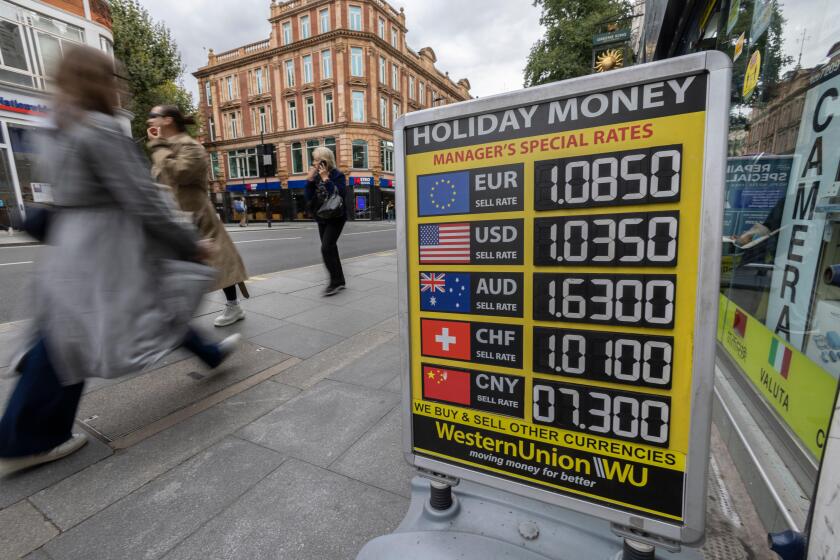 Holiday Money exchange rates advertised outside a bureau de change as the British pound hit a record low to $1.03, Tottenham Court Road, London, UK
