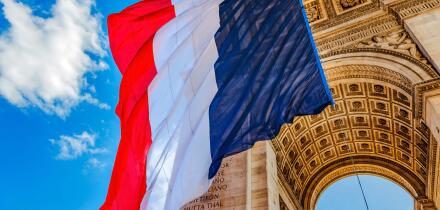 Arc de Triomphe and French flag, Paris, France. Completed in 1836 monument to the dead in the French Revolution and Napoleonic Wars. Includes Tomb to