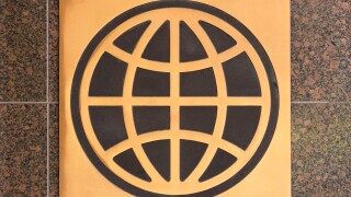 Logo sign of the UN World Bank Group on a granite wall outside a Washington DC office building