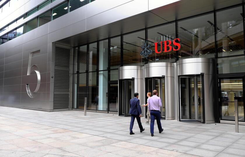 Entrance of 5 Broadgate UBS building exterior HQ headquarters sign people  financial services investment bank in the City of London UK   KATHY DEWITT