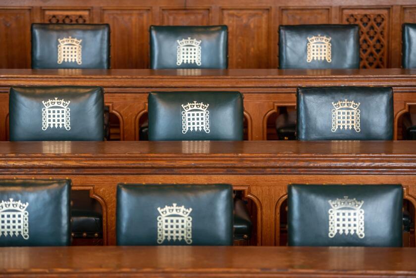 Empty seats in the Palace of Westminster. House of Commons meeting room.