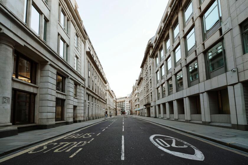 Low angle street shot of the deserted Moorgate on day 7 of the lockdown. The City of London, Mar 2020