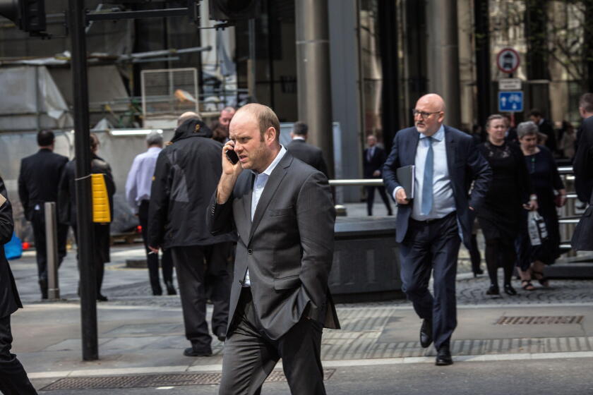 Great Britain / England /London /City of London / A City of London businessman speaking on his mobile phone.