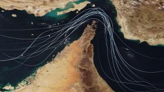 Satellite view of the Strait of Hormuz with white graphic lines representing global shipping lanes and maritime traffic between the Persian Gulf and G