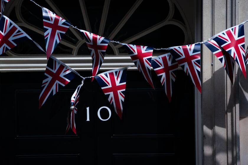 Union flag bunting is removed from the the front of No 10 Downing street after VE day, ahead of Prime Minister Boris Johnson address to the nation later this evening.