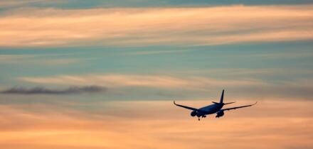 Airplane taking off in the sunset