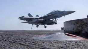 The USS Abraham Lincoln (CVN 72) is a Nimitz-class aircraft carrier in the U.S. Navy. The archival photograph captures an EA-18G Growler, attached to Electronic Attack Squadron (VAQ) 133, making an arrested landing on the flight deck on 28 February 2026 i