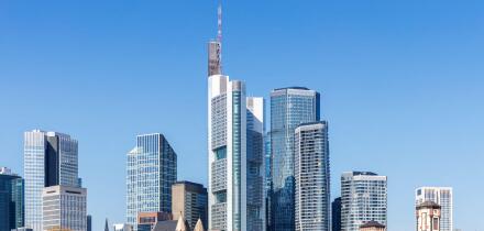 Frankfurt skyline skyscrapers with banks on River Main with bridge excursion boats in Frankfurt, Germany