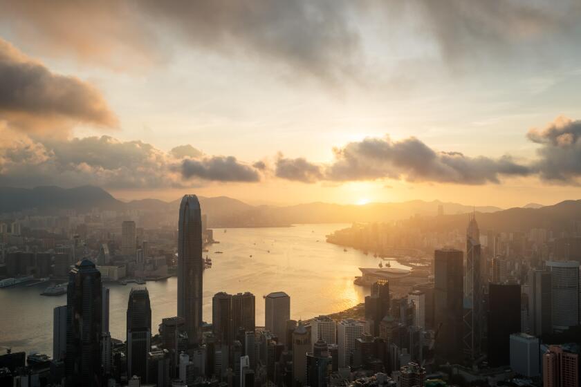 Sunrise over Hong Kong Victoria Harbor from Victoria Peak with Hong Kong and Kowloon below.