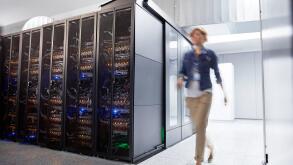 Female IT technician walking in server room