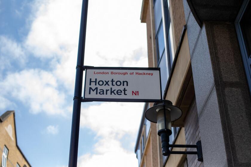 Street sign for Hoxton Market in the London Borough of Hackney under a clear sky.