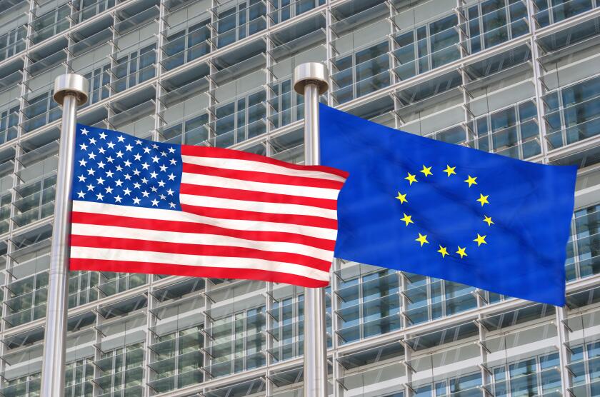 US and European flags waving in the wind (3D rendered)