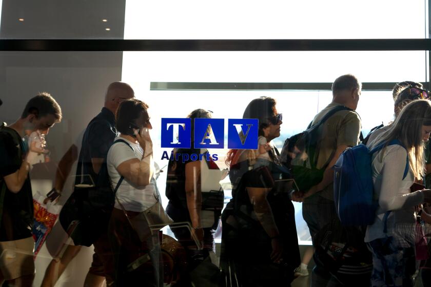 People waiting in line for departure in an airport's hallway