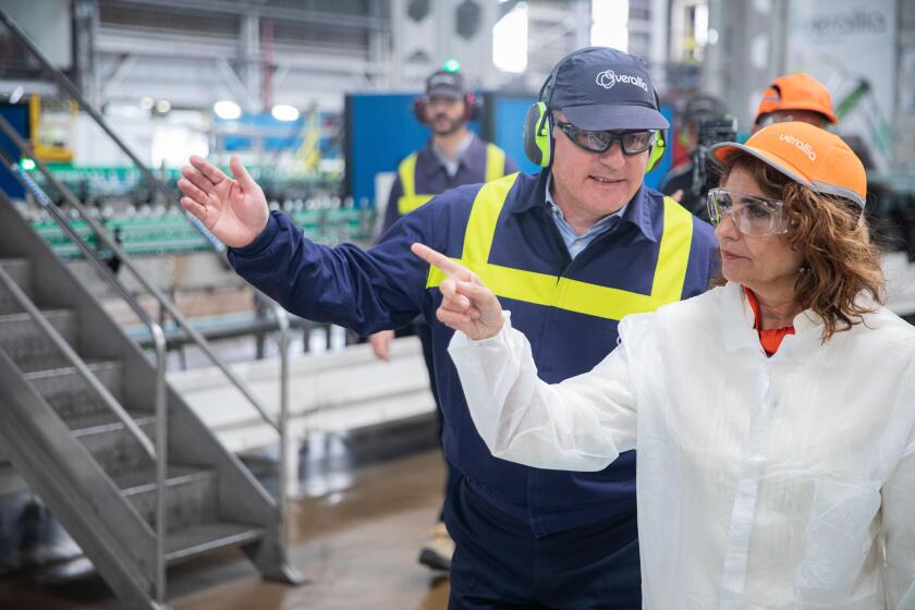 The Minister of Finance and Public Function, Maria Jesus Montero (right), with the plant manager, Teofilo Gangoso (left), during his visit to the glass factory. A 13 April 2023, in Seville (Andalusia, Spain). The Minister of Finance has addressed after hi