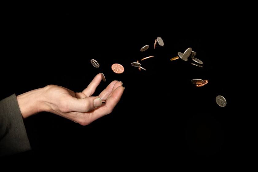 Caucasian male (42 yrs old) hand with money in the air depicting the concept of ?throwing money away?