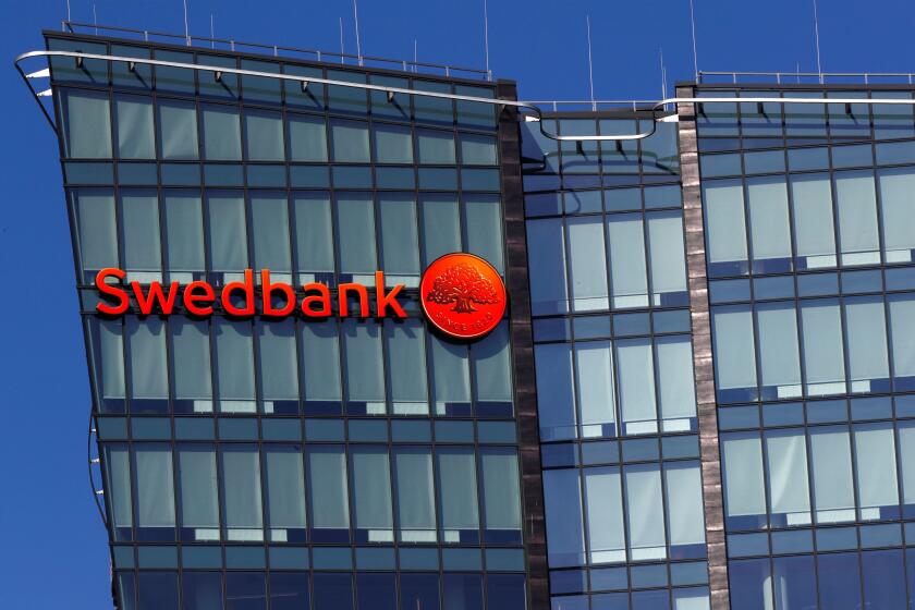 Swedbank sign is seen on the building in Vilnius, Lithuania March 30, 2019. REUTERS/Ints Kalnins