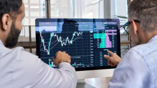 Two traders brokers stock exchange investors analyzing crypto trading charts.