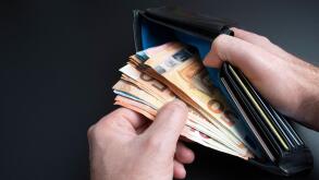 close-up high angle of view of hands of person taking money from purse or wallet