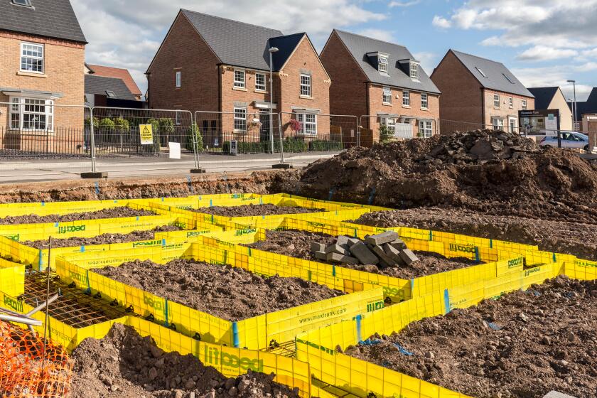 Newbuild houses on new estate with footings marked out for new house, Llanfoist, Abergavenny, UK