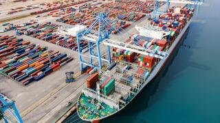 Container ship being loaded and unloaded at terminal freight port, international shipping and global commerce, modern cargo harbor and yard for mariti