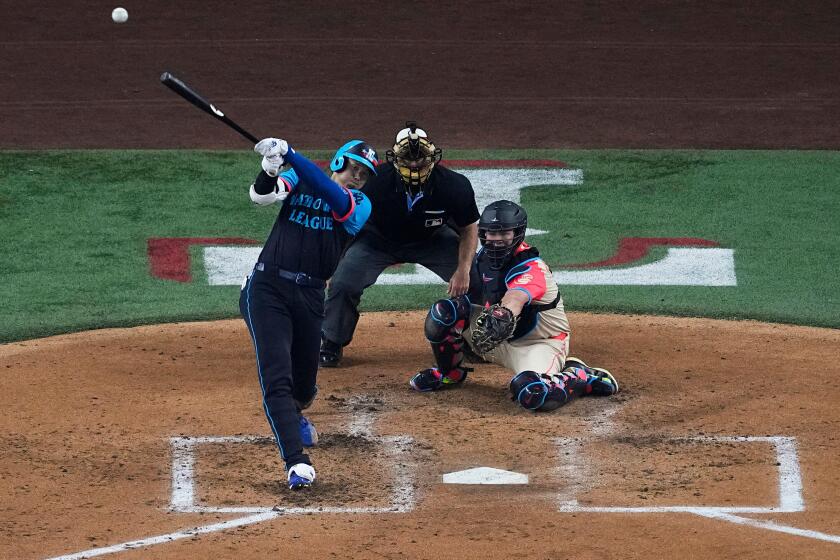 National League's Shohei Ohtani, of the Los Angeles Dodgers, hits a home run during the third inning of the MLB All-Star baseball game, Tuesday, July 16, 2024, in Arlington, Texas. Jurickson Profar, of the San Diego Padres, and Ketel Marte, of the Arizona