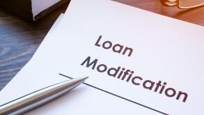 Papers about Loan modification on the table.