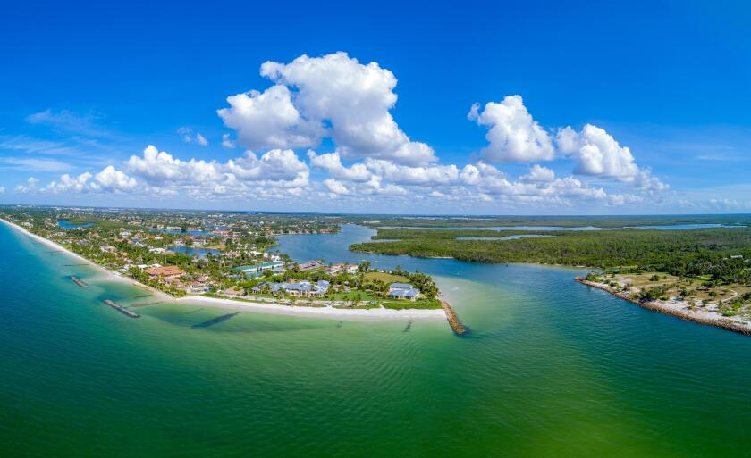 Aerial view of southern Naples FL at Gordon Pass overlooking Port Royal luxury real estate area.